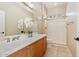 Bright bathroom featuring a neutral color palette, a walk-in shower, and a large vanity with decorative accents at 12820 W La Vina Dr, Sun City West, AZ 85375