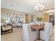 Elegant dining area featuring a modern chandelier, stylish furniture, and neutral color tones throughout at 12820 W La Vina Dr, Sun City West, AZ 85375