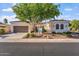 Charming single-story home with a red tile roof, landscaped front yard, and a spacious two-car garage at 12820 W La Vina Dr, Sun City West, AZ 85375