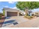Charming single-story home with a red tile roof, landscaped front yard, and a spacious two-car garage at 12820 W La Vina Dr, Sun City West, AZ 85375