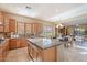Spacious kitchen with a large island, granite countertops, and adjacent living room at 12820 W La Vina Dr, Sun City West, AZ 85375