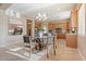 Sunlit kitchen with stainless appliances, granite countertops and unique wood and glass dining table at 12820 W La Vina Dr, Sun City West, AZ 85375
