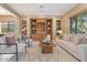 Comfortable living room includes built-in shelves, a ceiling fan, and large windows for natural light at 12820 W La Vina Dr, Sun City West, AZ 85375
