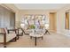 Inviting living room features neutral paint, stylish furniture and decor, and abundant natural light at 12820 W La Vina Dr, Sun City West, AZ 85375