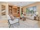 Spacious living room features built-in shelving, comfortable seating, and abundant natural light at 12820 W La Vina Dr, Sun City West, AZ 85375