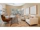 Bright home office features a bay window, modern desk, and comfortable seating for a productive workspace at 12820 W La Vina Dr, Sun City West, AZ 85375