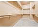 Spacious walk-in closet with neutral walls and ample shelving at 12820 W La Vina Dr, Sun City West, AZ 85375