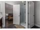 Modern bathroom features white shower and white door which enters into another room with a large bed at 1551 E Longhorn Dr, Chandler, AZ 85286
