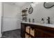Modern bathroom with double sinks, updated vanity, subway tile backsplash, black fixtures and rustic shelving at 1551 E Longhorn Dr, Chandler, AZ 85286