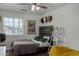 Cozy bedroom with a wooden headboard, boho style decorations, and view of the neighborhood through the window at 1551 E Longhorn Dr, Chandler, AZ 85286