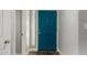 Stylish teal front door with modern hardware and wood flooring creating a welcoming entryway at 1551 E Longhorn Dr, Chandler, AZ 85286