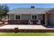 Inviting front porch with brick accents and charming rocking chairs, perfect for relaxing and enjoying the outdoors at 1551 E Longhorn Dr, Chandler, AZ 85286