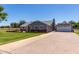 Inviting single-story home with a well-maintained lawn and a detached garage featuring a basketball hoop at 1551 E Longhorn Dr, Chandler, AZ 85286
