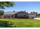 Inviting single-story home with a lush green lawn, brick accents, and a detached garage with a basketball hoop at 1551 E Longhorn Dr, Chandler, AZ 85286