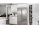 Bright kitchen featuring stainless steel refrigerator, white cabinets, and subway tile backsplash at 1551 E Longhorn Dr, Chandler, AZ 85286
