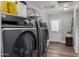 Laundry room features a Kenmore washer and dryer, a hot water tank, and wood-look flooring at 1551 E Longhorn Dr, Chandler, AZ 85286