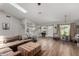 Open-concept living room with skylight, modern flooring, and seamless flow to kitchen at 1551 E Longhorn Dr, Chandler, AZ 85286