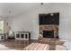 Bright living room featuring a brick fireplace, modern flooring, and neutral decor at 1551 E Longhorn Dr, Chandler, AZ 85286