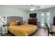 Cozy main bedroom with ceiling fan, ensuite, and French doors with natural light at 1551 E Longhorn Dr, Chandler, AZ 85286