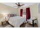 Relaxing bedroom featuring a ceiling fan, wood-look floors, and a large window at 17424 N 1St Ave, Phoenix, AZ 85023