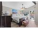 Comfortable primary bedroom with a vaulted ceiling, ceiling fan, backyard views and wood-look floors at 17424 N 1St Ave, Phoenix, AZ 85023