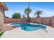 Relaxing kidney-shaped pool featuring desert landscape and a privacy wall at 17424 N 1St Ave, Phoenix, AZ 85023