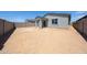Spacious backyard with block wall, covered patio, and low-maintenance desert landscaping at 18219 W Daley Ln, Surprise, AZ 85387