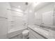 A modern bathroom featuring a tub and shower combination and a vanity with granite countertops at 18219 W Daley Ln, Surprise, AZ 85387