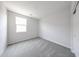 Comfortable bedroom features plush carpeting, natural light from the window, and a spacious closet at 18219 W Daley Ln, Surprise, AZ 85387