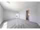 Expansive carpeted bedroom featuring multiple doorways, and neutral walls at 18219 W Daley Ln, Surprise, AZ 85387