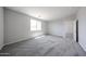 Comfortable bedroom with carpet, a view from the window, and an adjoining room at 18219 W Daley Ln, Surprise, AZ 85387