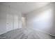 Cozy bedroom with plush carpeting and closet provides a relaxing space for rest and rejuvenation at 18219 W Daley Ln, Surprise, AZ 85387