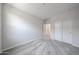 A neutral bedroom features plush carpeting and a closet, creating a serene and comfortable space at 18219 W Daley Ln, Surprise, AZ 85387