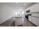 Open kitchen boasts a granite island, stainless appliances, and seamless flow into the adjacent living area at 18219 W Daley Ln, Surprise, AZ 85387