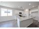 Bright kitchen boasts granite countertops, white cabinetry, and stainless steel appliances at 18219 W Daley Ln, Surprise, AZ 85387