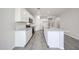 Well-lit kitchen with white cabinetry, granite countertops, and modern appliances at 18219 W Daley Ln, Surprise, AZ 85387