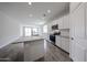 Well-lit kitchen with a central island, stainless steel appliances, and white cabinetry, perfect for modern living at 18219 W Daley Ln, Surprise, AZ 85387