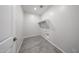 A compact laundry room with hookups, shelving, and neutral-colored walls at 18219 W Daley Ln, Surprise, AZ 85387