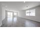 Spacious living room features tile flooring, large sliding glass doors, and ample natural light for comfortable living at 18219 W Daley Ln, Surprise, AZ 85387