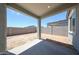 A concrete covered patio overlooking a large dirt backyard with cinderblock perimeter fence at 18219 W Daley Ln, Surprise, AZ 85387