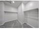 Simple walk-in closet provides ample storage, carpeted floor, and overhead lighting at 18219 W Daley Ln, Surprise, AZ 85387