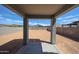 Expansive backyard with a covered patio and block fence offers privacy and outdoor living at 18236 W Daley Ln, Surprise, AZ 85387