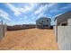 Spacious backyard featuring a privacy fence and covered patio, perfect for entertaining and outdoor enjoyment at 18236 W Daley Ln, Surprise, AZ 85387