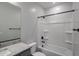 Modern bathroom featuring a granite countertop, sleek fixtures, and a shower-tub combination at 18236 W Daley Ln, Surprise, AZ 85387