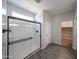 Bathroom showcasing glass-enclosed shower, tile flooring, and neutral paint at 18236 W Daley Ln, Surprise, AZ 85387