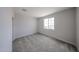 Clean bedroom with carpeted floors and bright window at 18236 W Daley Ln, Surprise, AZ 85387