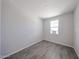 Minimalist bedroom with tile flooring and a bright window, perfect for a serene retreat at 18236 W Daley Ln, Surprise, AZ 85387