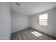 Clean bedroom with carpeted floors and bright window at 18236 W Daley Ln, Surprise, AZ 85387