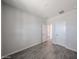 A clean, bright bedroom with tile flooring and two white doors, creating a versatile space at 18236 W Daley Ln, Surprise, AZ 85387