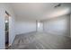 Well-lit bedroom offers soft carpeting, neutral walls, and entrance to ensuite bathroom at 18236 W Daley Ln, Surprise, AZ 85387